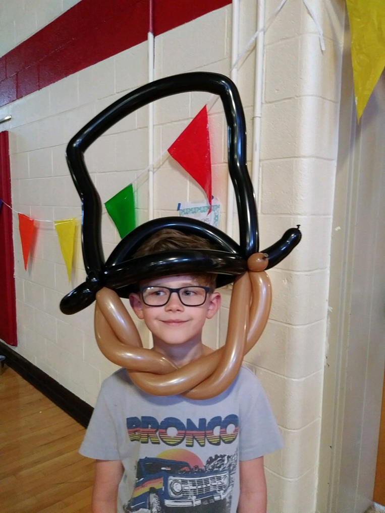 Boy wearing a balloon pirate hat with mustache